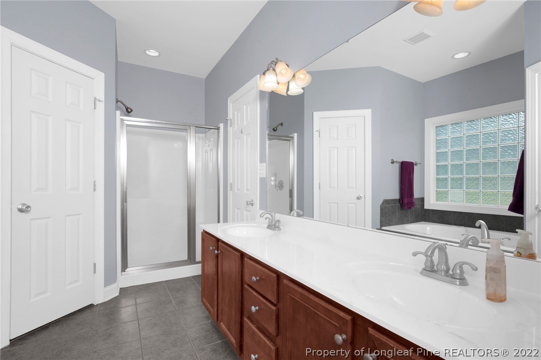 515 Booth Pond Road Raeford, NC 28376 - Photo 31 of 39 a bathroom with a double vanity sink mirror and shower