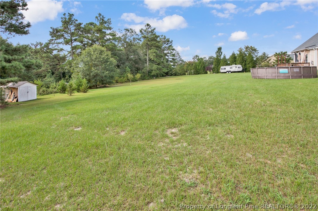 515 Booth Pond Road Raeford, NC 28376 - Photo 36 of 39 a view of a field of grass and trees