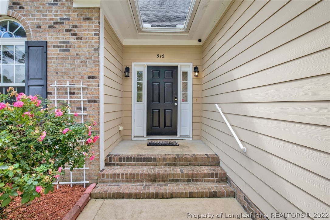 515 Booth Pond Road Raeford, NC 28376 - Photo 5 of 39 a front view of a house with a potted plant and garage