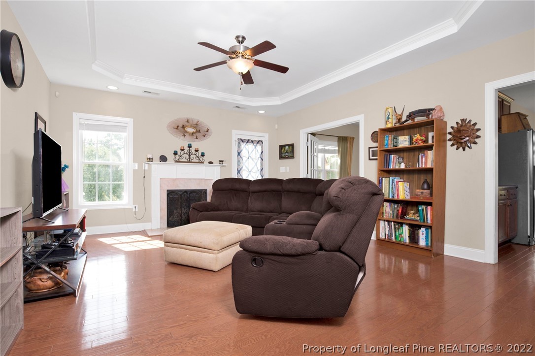 515 Booth Pond Road Raeford, NC 28376 - Photo 7 of 39 a living room with furniture a bookshelf and a flat screen tv
