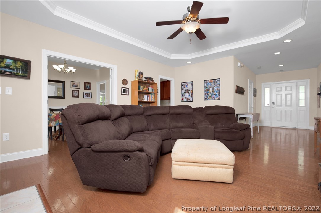 515 Booth Pond Road Raeford, NC 28376 - Photo 8 of 39 a living room with furniture and a chandelier