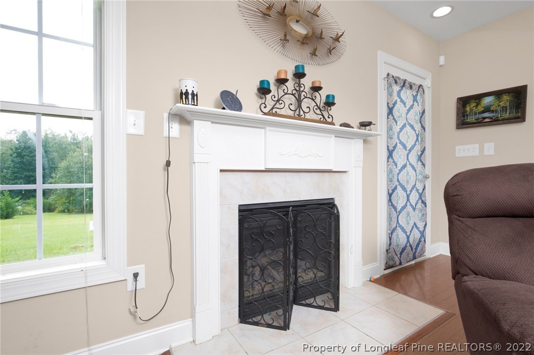 515 Booth Pond Road Raeford, NC 28376 - Photo 10 of 39 a living room with a fireplace and a large window