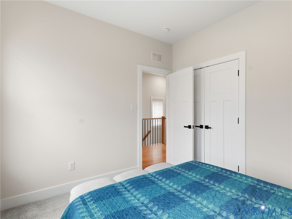 1202 North 34th Street Richmond, VA 23223 - Photo 26 of 36 Bedroom with light colored carpet and a closet