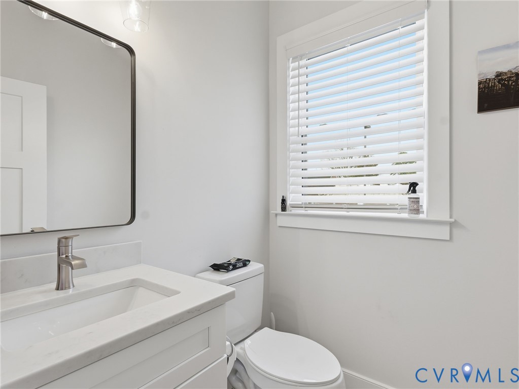 1202 North 34th Street Richmond, VA 23223 - Photo 27 of 36 Half bath featuring vanity and toilet