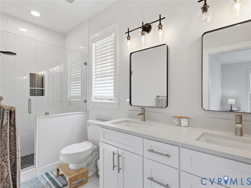 1202 North 34th Street Richmond, VA 23223 - Photo 28 of 36 Full bathroom with double vanity and a shower stal