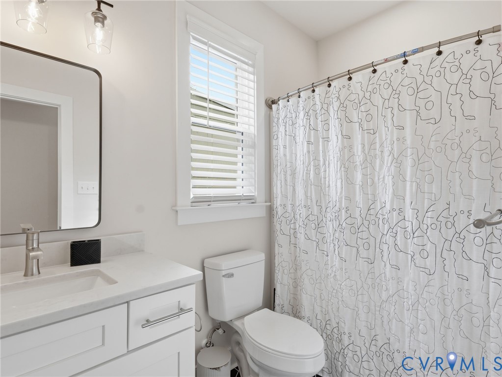 1202 North 34th Street Richmond, VA 23223 - Photo 29 of 36 Full bathroom featuring vanity and curtained showe
