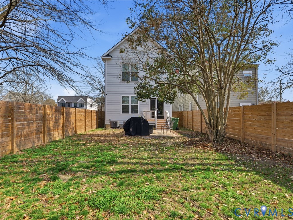 1202 North 34th Street Richmond, VA 23223 - Photo 32 of 36 Rear view of house with a fenced backyard