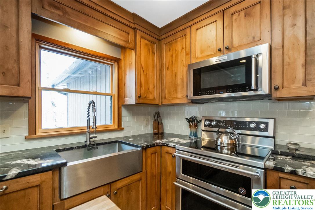 143 Moseywood Road Lake Harmony, PA 18624 - Photo 12 of 48 a kitchen with stainless steel appliances granite countertop a stove a sink and a microwave