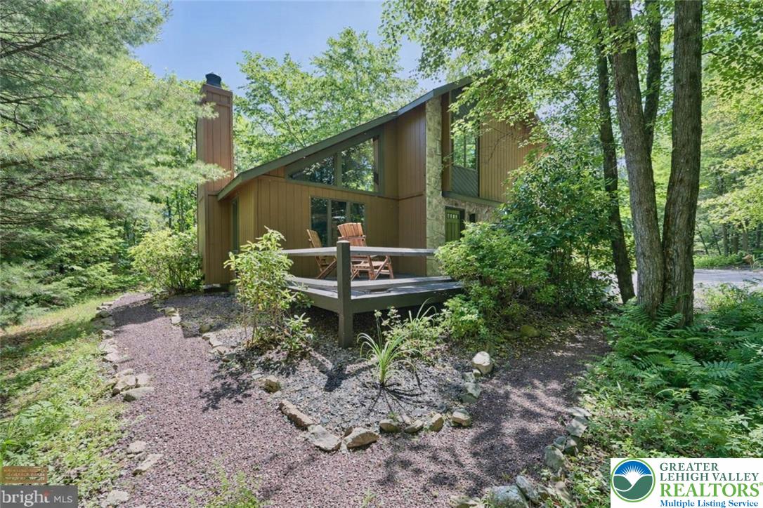 143 Moseywood Road Lake Harmony, PA 18624 - Photo 2 of 48 a backyard of a house with a yard and outdoor seating