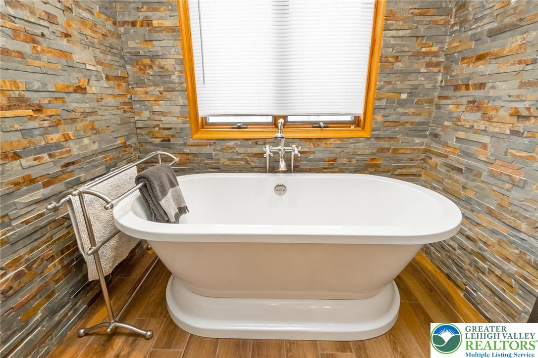 143 Moseywood Road Lake Harmony, PA 18624 - Photo 22 of 48 a white bath tub sitting in a bathroom