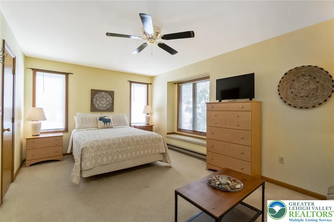 143 Moseywood Road Lake Harmony, PA 18624 - Photo 23 of 48 a bedroom with a bed and a chandelier
