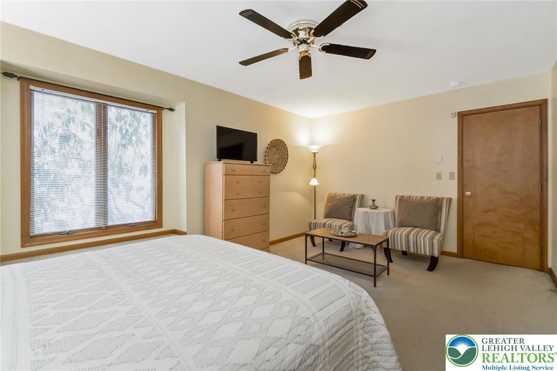 143 Moseywood Road Lake Harmony, PA 18624 - Photo 24 of 48 a bedroom with a bed a couch and a large window