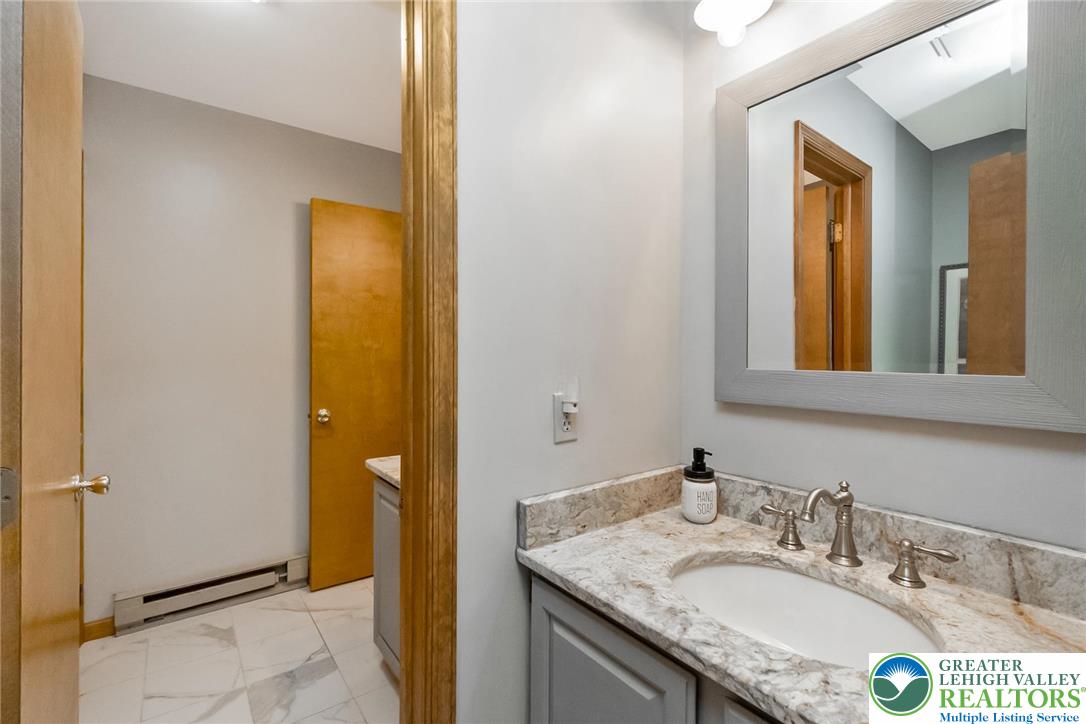 143 Moseywood Road Lake Harmony, PA 18624 - Photo 27 of 48 a bathroom with a granite countertop sink and a mirror