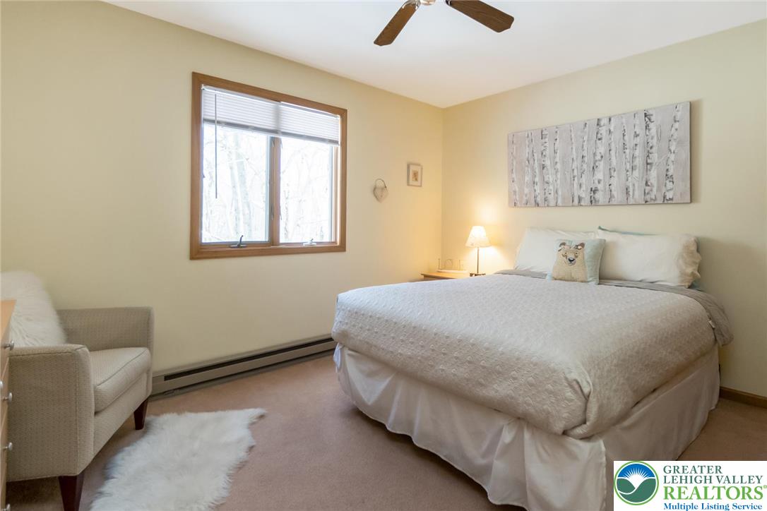 143 Moseywood Road Lake Harmony, PA 18624 - Photo 32 of 48 a bedroom with a bed and a couch