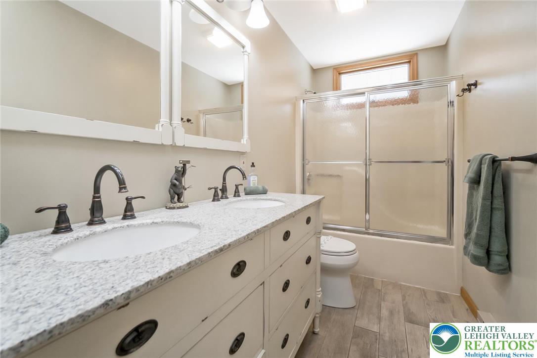143 Moseywood Road Lake Harmony, PA 18624 - Photo 34 of 48 a bathroom with a granite countertop sink toilet and shower