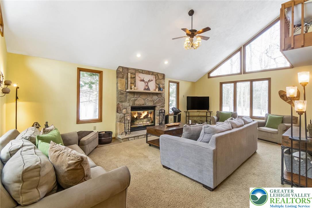 143 Moseywood Road Lake Harmony, PA 18624 - Photo 5 of 48 a living room with furniture fireplace and a large window