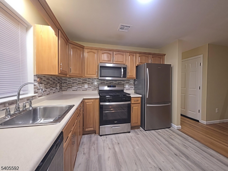 94 Palm Street, Unit 1 Newark, NJ 07106 - Photo 17 of 24 a kitchen with granite countertop a refrigerator and a sink