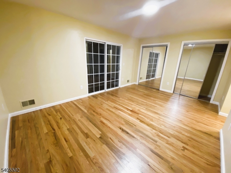 94 Palm Street, Unit 1 Newark, NJ 07106 - Photo 4 of 24 a view of empty room with wooden floor and stairs