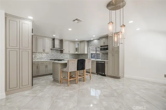 a kitchen with a sink cabinets and stainless steel appliances