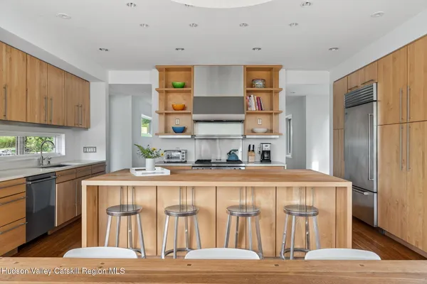 a kitchen with stainless steel appliances granite countertop a stove and a sink