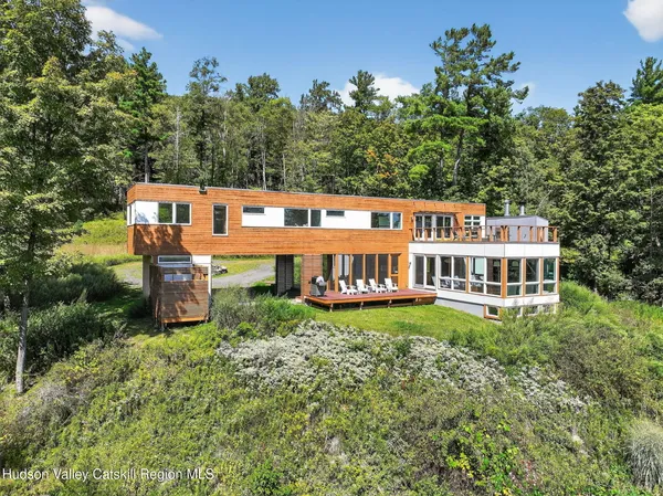 aerial view of a house with porch and garden