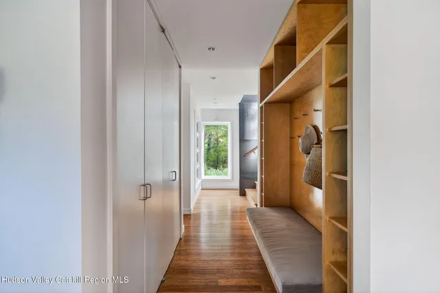 a view of a hallway with wooden floor and staircase