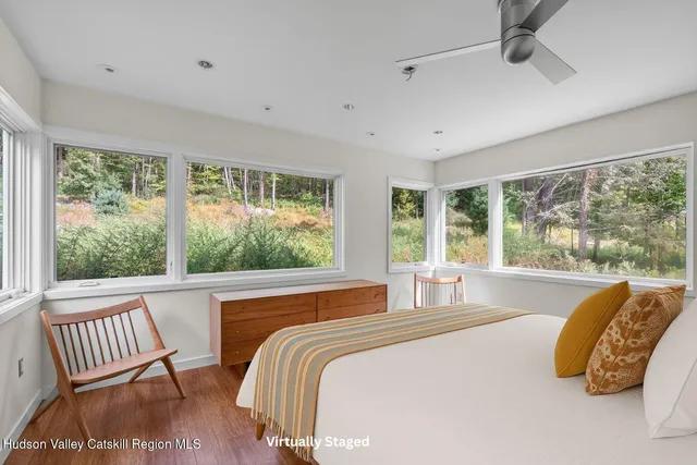 a bedroom with a bed and a large window