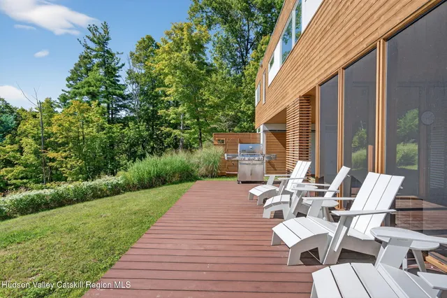 a view of backyard with outdoor seating and green space
