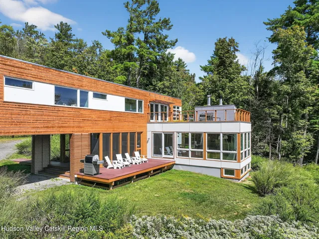 a view of a house with a backyard and a patio
