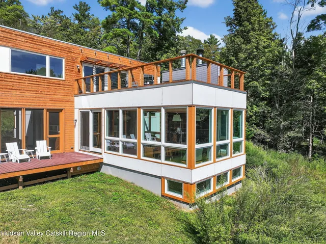 a front view of a house with a yard and potted plants