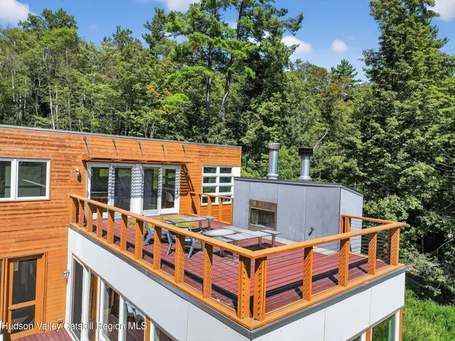 an aerial view of a house with balcony and trees