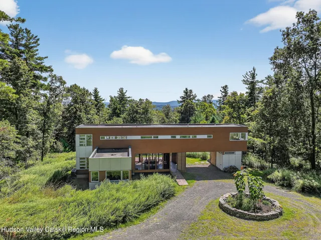 a view of a house with a yard balcony and seating area