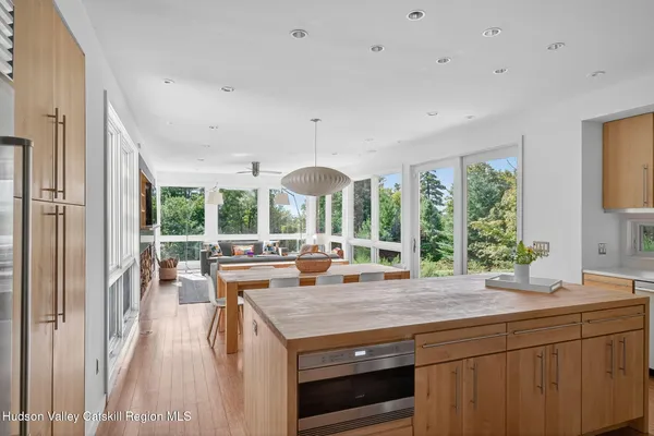 a view of a kitchen with a large window and dining table