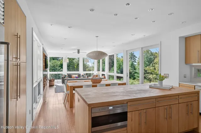 a view of a kitchen with a large window and dining table