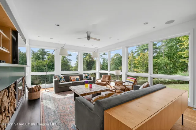 a living room with furniture and a floor to ceiling window