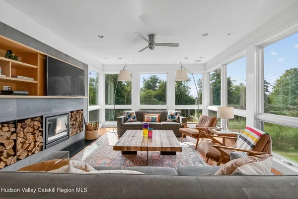 a living room with furniture and large windows