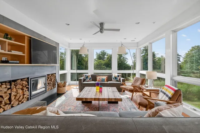 a living room with furniture and large windows