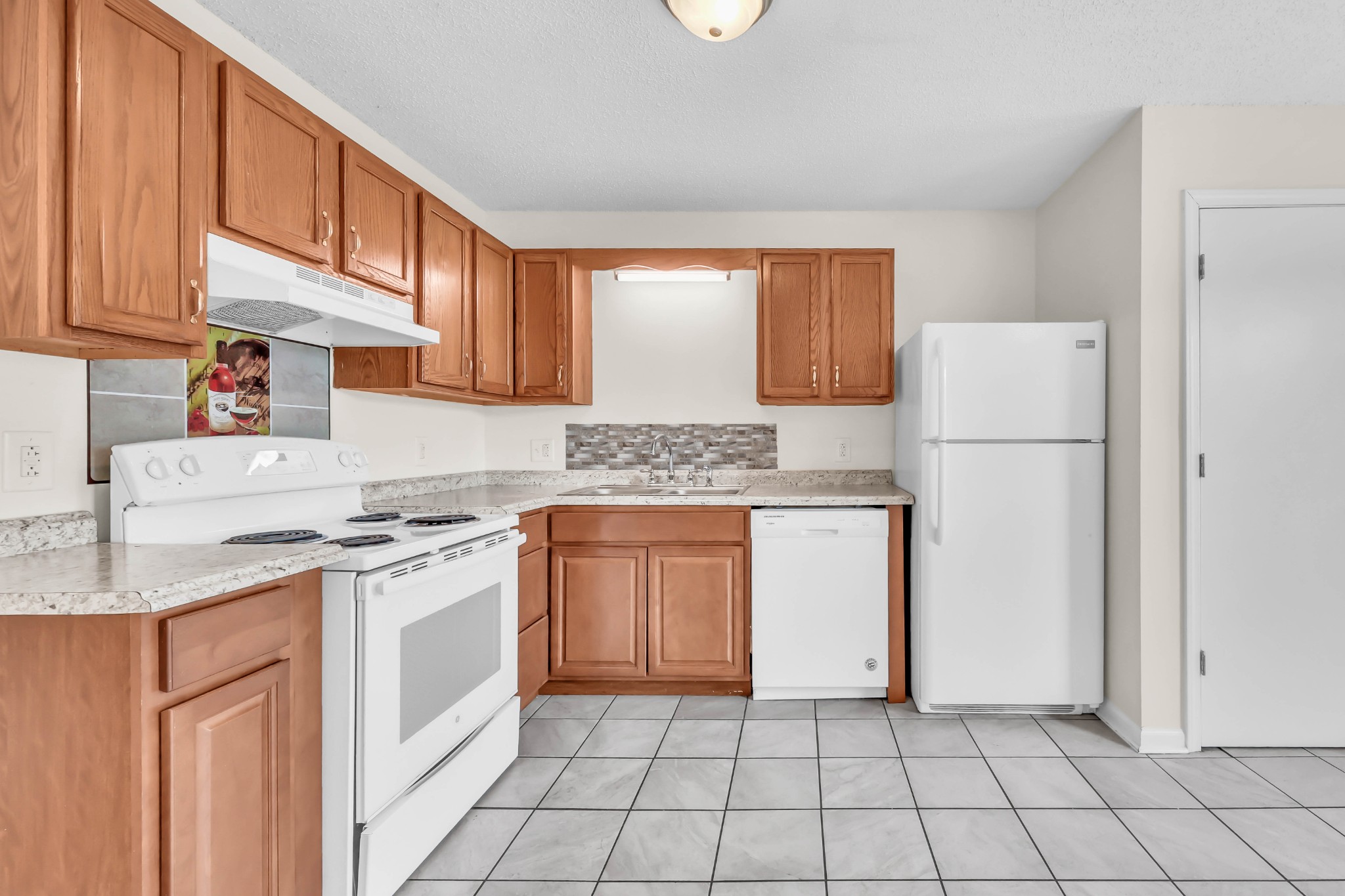 2451 Wilson Road, Unit 6 Clarksville, TN 37043 - Photo 9 of 21 a kitchen with a sink a stove a refrigerator and cabinets