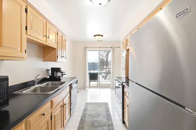 a kitchen that has a sink a counter top space and cabinets