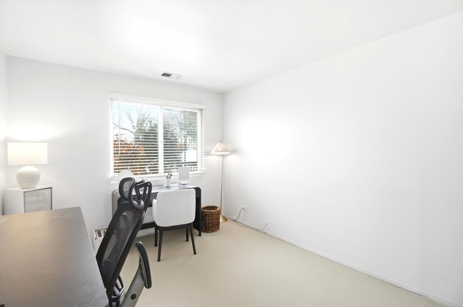 8640 Waukegan Road, Unit 123 Morton Grove, IL 60053 - Photo 15 of 30 a view of a livingroom with a chair and a potted plant