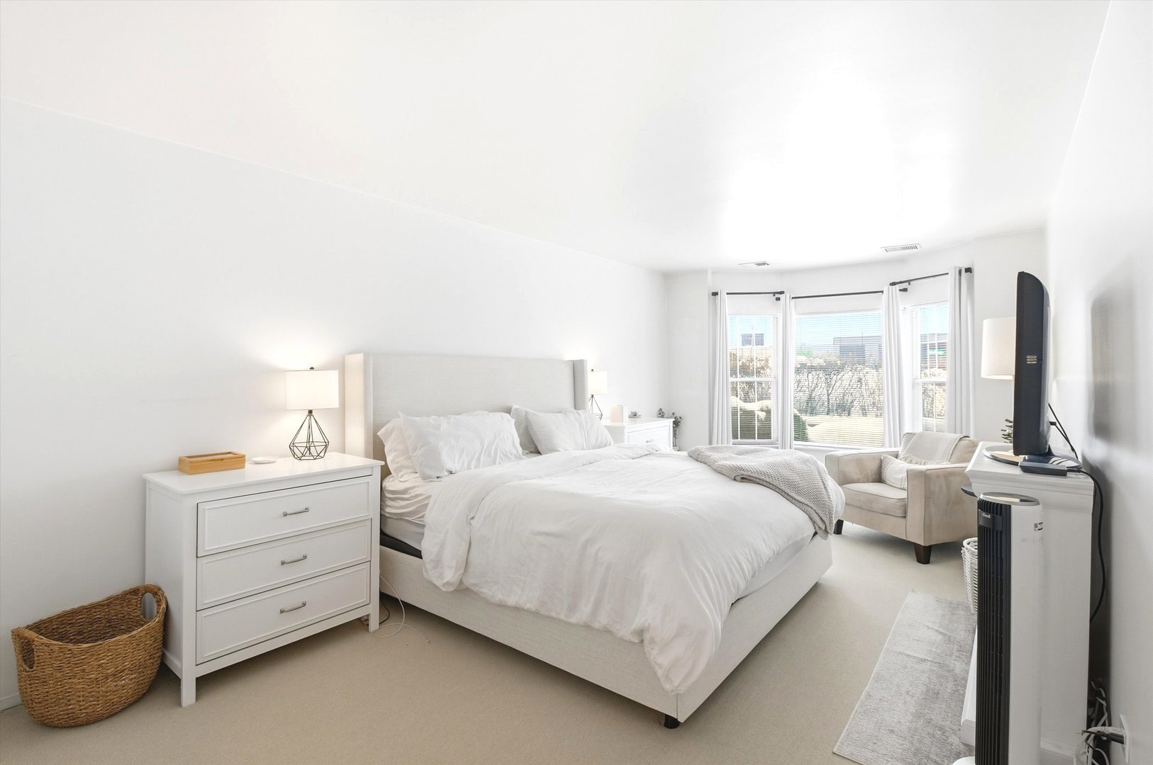 8640 Waukegan Road, Unit 123 Morton Grove, IL 60053 - Photo 16 of 30 a bedroom with a bed and large windows