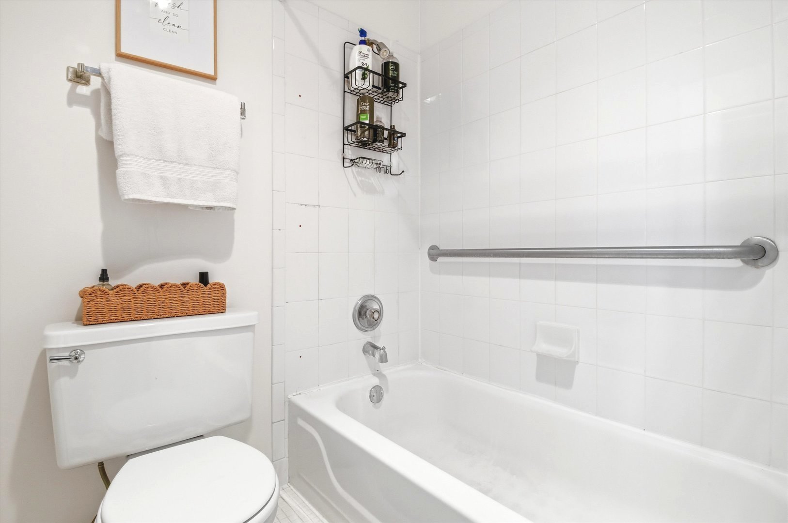 8640 Waukegan Road, Unit 123 Morton Grove, IL 60053 - Photo 22 of 30 a bathroom with a sink a toilet and bathtub