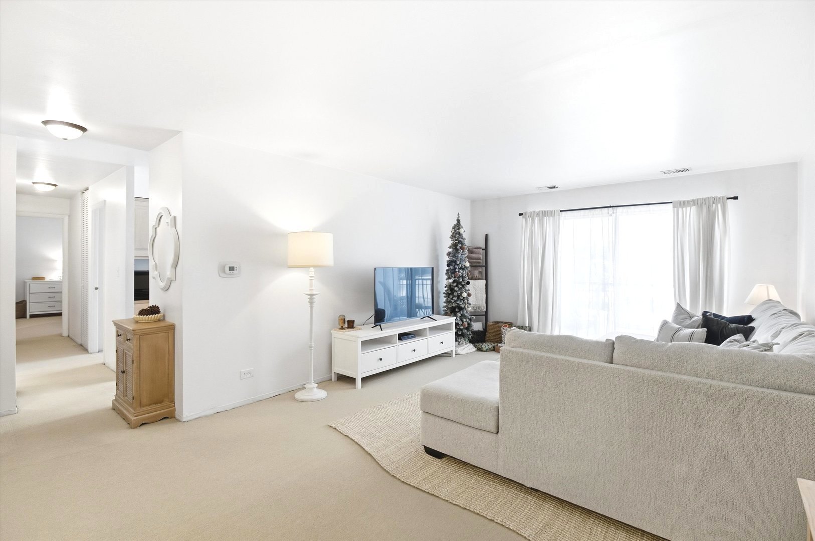 8640 Waukegan Road, Unit 123 Morton Grove, IL 60053 - Photo 6 of 30 a living room with furniture and a large window