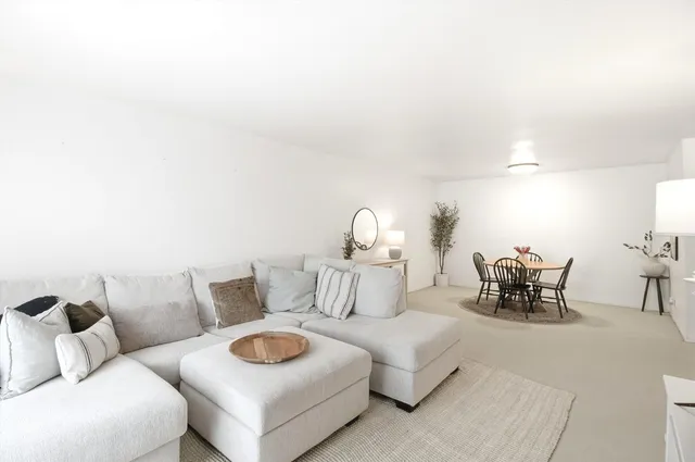 a living room with furniture and a lamp