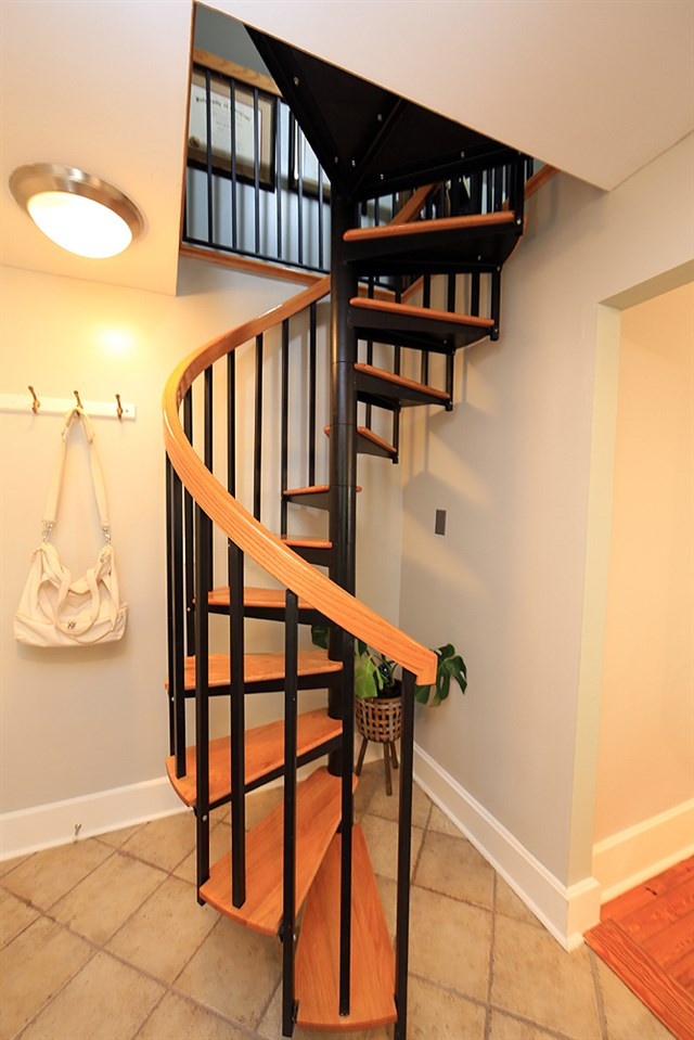 1530 Carson Street Raleigh, NC 27608 - Photo 8 of 21 The spiral staircase is located off the kitchen. Staircase