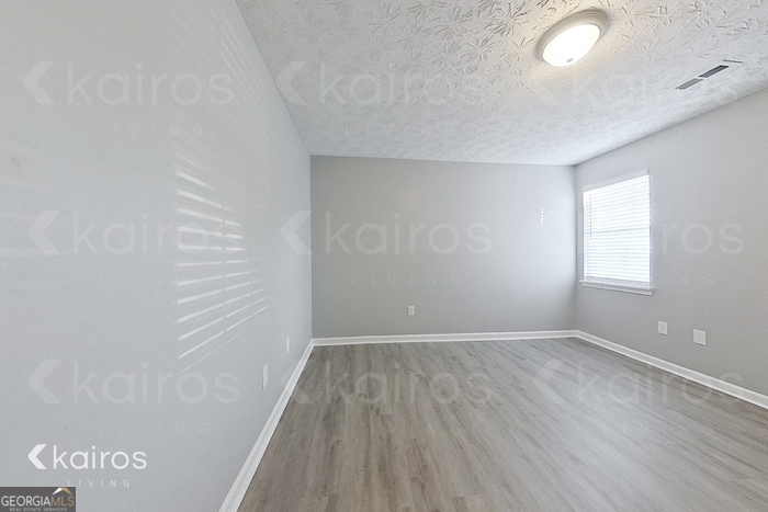 200 Deer Parkway Athens, GA 30605 - Photo 8 of 15 an empty room with wooden floor and windows