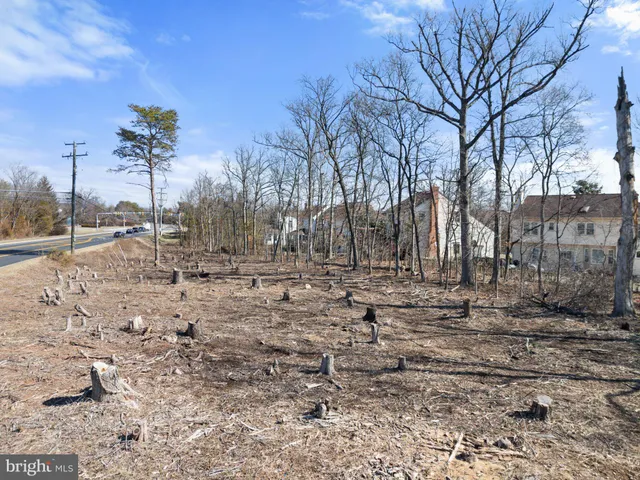 a view of a backyard space with wooden fence