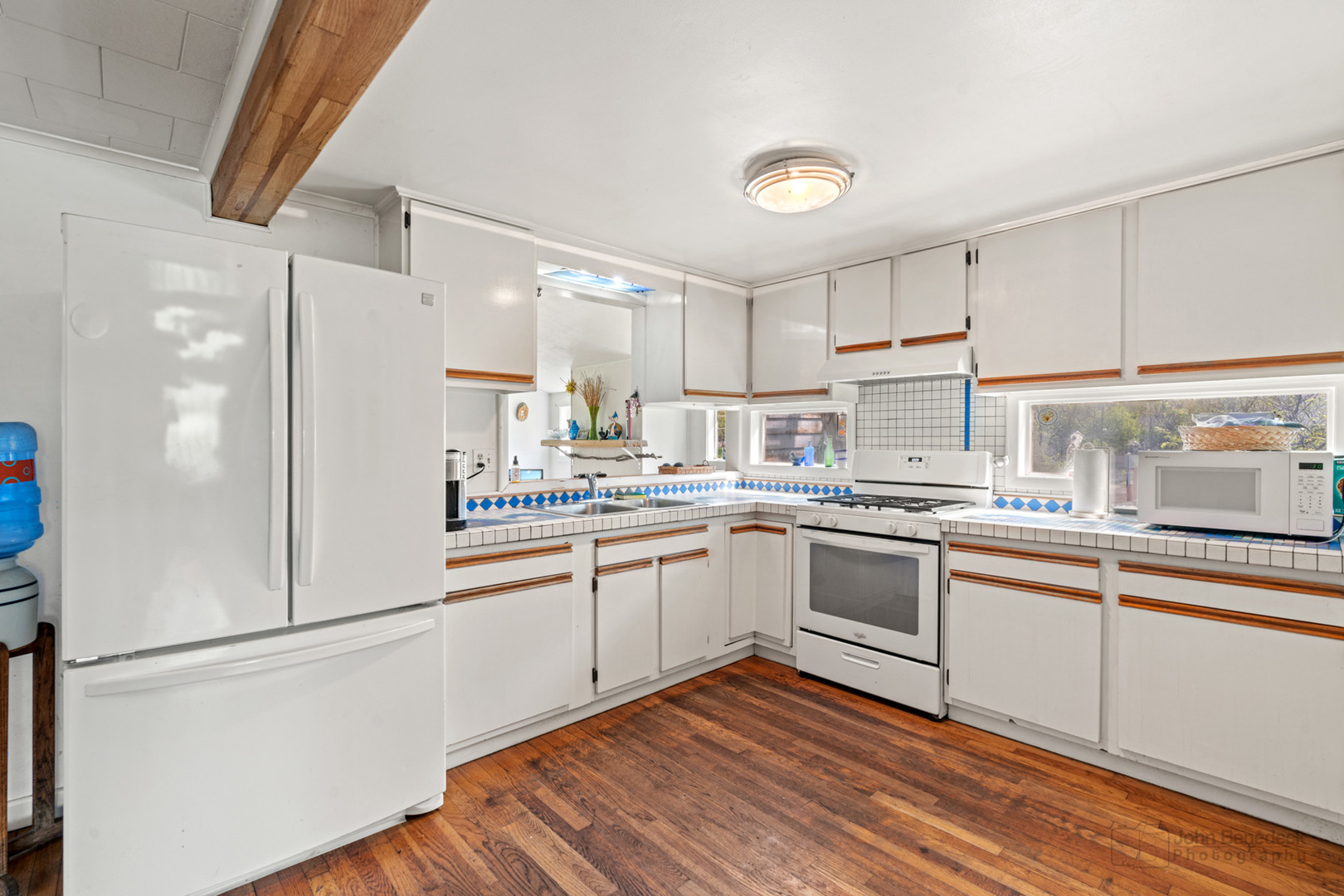 1307 Tower Lane Cary, IL 60013 - Photo 5 of 26 a kitchen with white cabinets and white appliances