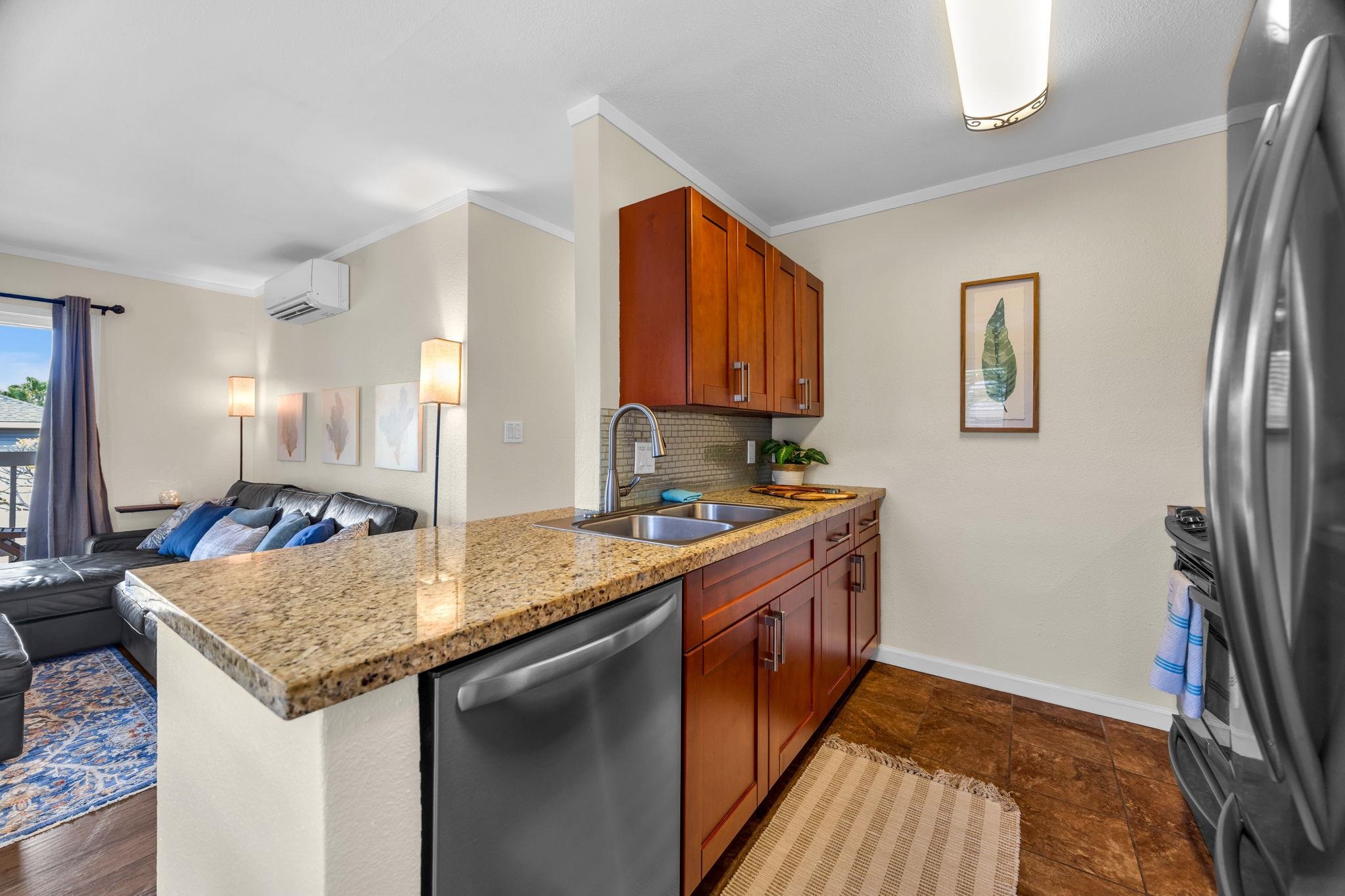 140 Uwapo Road, Unit 53201 Kihei, HI 96753 - Photo 11 of 28 a kitchen with stainless steel appliances granite countertop a sink stove and refrigerator