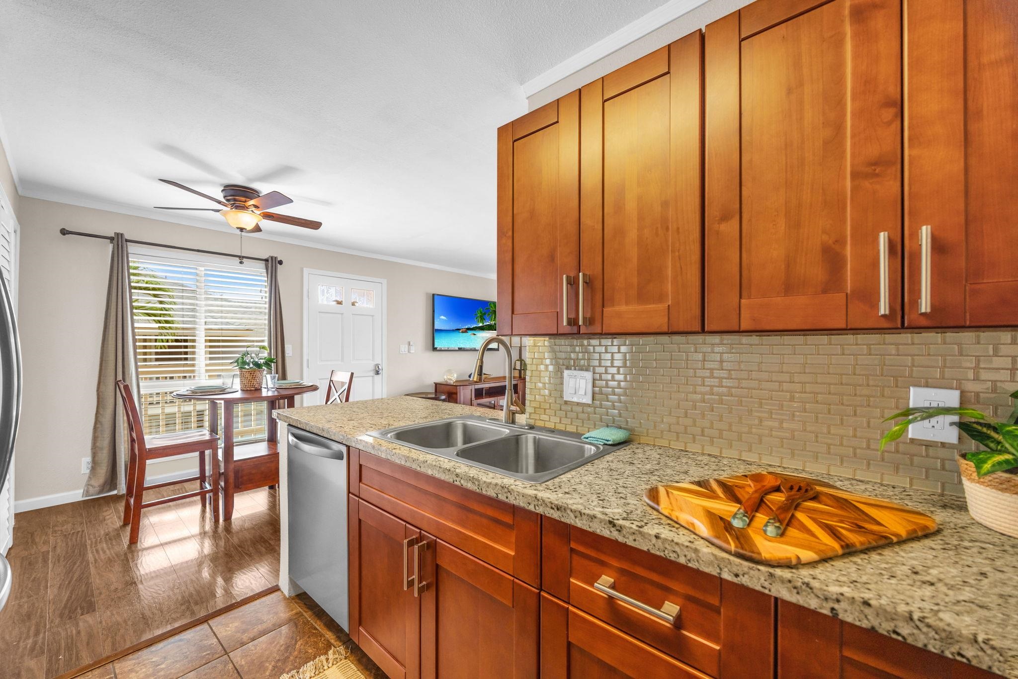 140 Uwapo Road, Unit 53201 Kihei, HI 96753 - Photo 12 of 28 a kitchen with stainless steel appliances granite countertop a sink stove and cabinets